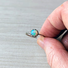 Load image into Gallery viewer, Opal ring held between fingers on a neutral background
