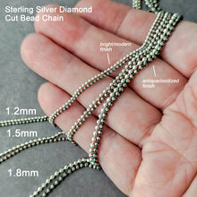 Load image into Gallery viewer, Close up of diamond cut bead chains in three sizes and 2 finishes held in a hand for scale
