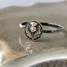 Load image into Gallery viewer, Silver ring with a thistle design on a textured surface
