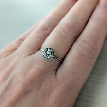 Load image into Gallery viewer, Silver ring with an intricate thistle design on a person&#39;s finger against a neutral background
