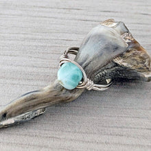 Load image into Gallery viewer, Turquoise color larimar stone ring on silver wire against a natural background
