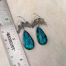 Load image into Gallery viewer, Pair of blue teardrop earrings with silver tops on a light background with a ruler for scale.
