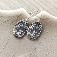 Load image into Gallery viewer, Silver earrings with intricate designs on a textured surface
