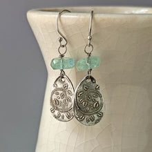 Load image into Gallery viewer, Silver earrings with green beads on a ceramic stand
