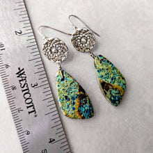 Load image into Gallery viewer, Pair of silver topped earrings with green and blue patterned gemstone drops next to a ruler for scale.
